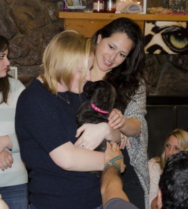 New interns Lauren Dafoe and Lee Rodriguez make a new friend at the going away party for the outgoing intern class.